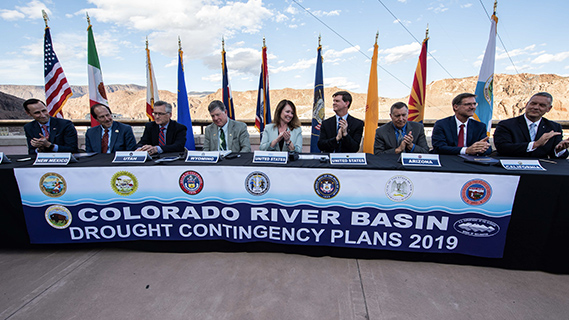 Representatives sitting at a table to discuss the Colorado River Drought Contingency Plan