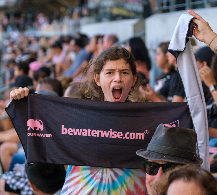 Photo of young girl holding a bewaterwise.com banner.